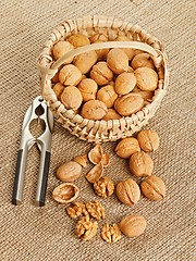 Image showing Walnut in basket and nut cracker