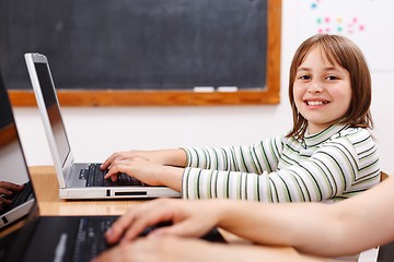 Image showing Cheerful schoolgirl with laptop