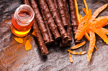 Image showing chocolate sticks with orange