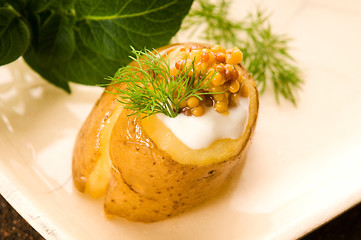 Image showing Baked potato with sour cream, grain Dijon mustard and herbs