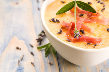 Image showing fresh melon soup with parma ham and lavender flower