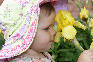 Image showing Little girl with yellow flower