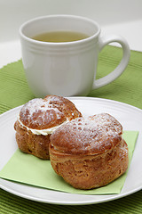 Image showing Two profiteroles and tea