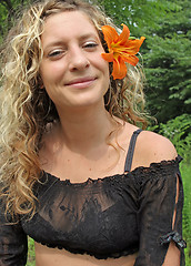 Image showing Orange flower in her ear