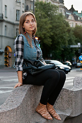 Image showing girl sitting on a street