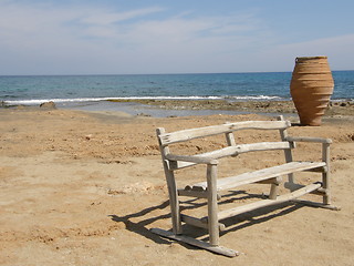 Image showing A pot and a bench on the seashore