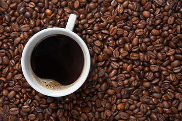 Image showing Coffee cup on background of beans