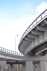 Image showing automobile overpass on background of blue sky with clouds. botto