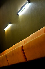 Image showing Beige couch and lights in a room with dark green walls