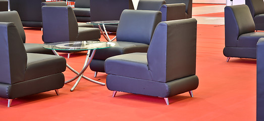 Image showing black armchairs on the red floor