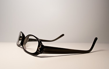 Image showing Black glasses over white background