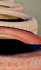 Image showing close up of racetrack fence of  red  old tires