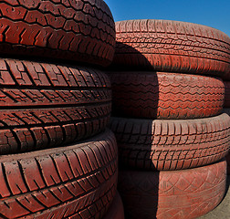 Image showing close up of racetrack fence of  red old tires