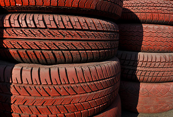 Image showing close up of racetrack fence of  red old tires