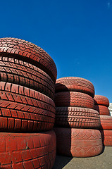 Image showing close up of racetrack fence of  red old tires