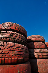 Image showing close up of racetrack fence of  red old tires