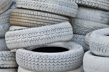 Image showing close-up. the white automobile tires dumped in a a big pile