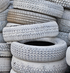 Image showing close-up. the white automobile tires dumped in a a big pile