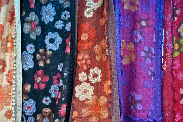 Image showing colorful patterned fabrics hanging in a row