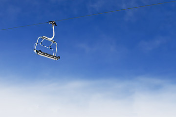 Image showing Ski lift chair on bright blue sky