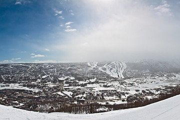 Image showing Panorama of winter mountain slopes with ski routes and snowstorm