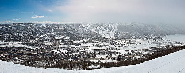 Image showing Panoramic view of small city in the valley with winter mountain 