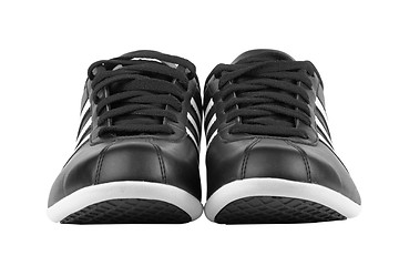 Image showing Black sneakers with white strips