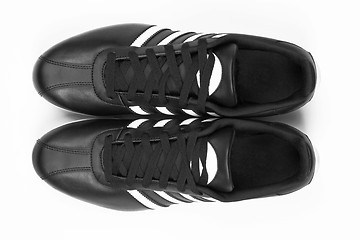 Image showing Black sneakers with white strips