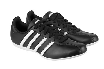 Image showing Black sneakers with white strips