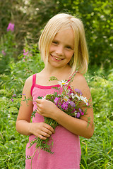 Image showing Smiling Girl with Flowers Outdoor