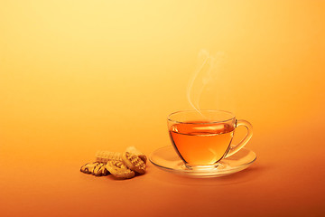 Image showing Cup of hot tea with chocolate cookies