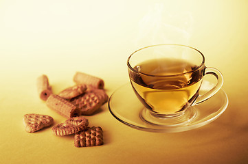 Image showing Cup of hot tea with cookies