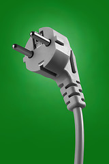 Image showing electrical cable with plug on green background