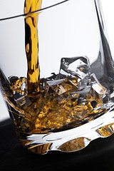 Image showing glass of whiskey and ice