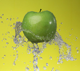 Image showing Green apple on yellow background