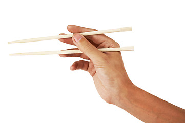 Image showing Hand holding chopsticks