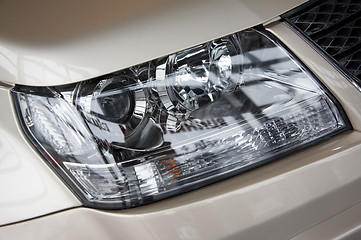 Image showing headlight on a beige car