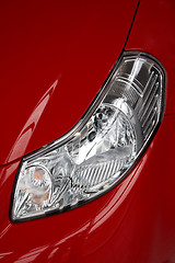 Image showing headlight on a red car