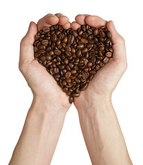 Image showing Heart shape made from coffee beans in hands