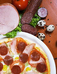 Image showing Pizza with salami, ham, edd and tomato