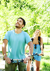 Image showing Young happy couple riding a bicycle