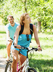 Image showing Young happy couple riding a bicycle