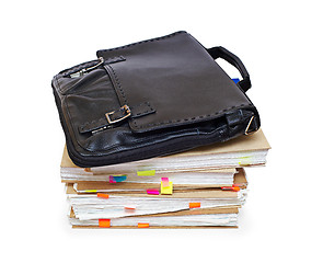 Image showing Leather portfolio lying on account books