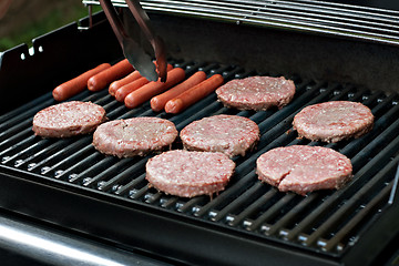 Image showing Hot Dogs and Hamburgers on the Grill