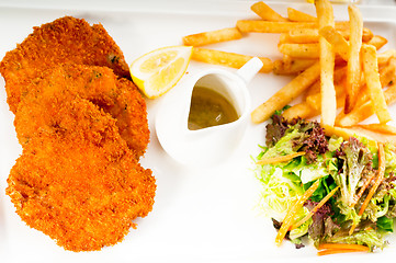 Image showing classic Milanese veal cutlets and vegetables