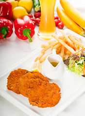 Image showing classic Milanese veal cutlets and vegetables