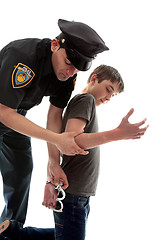 Image showing Policeman arresting teen criminal