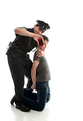 Image showing Happy policeman with apprehended teen boy