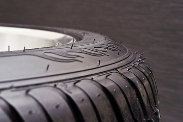 Image showing low-profile car wheel on a black background close up