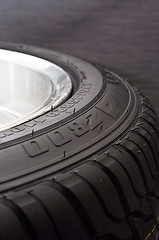 Image showing low-profile car wheel on a black background close up